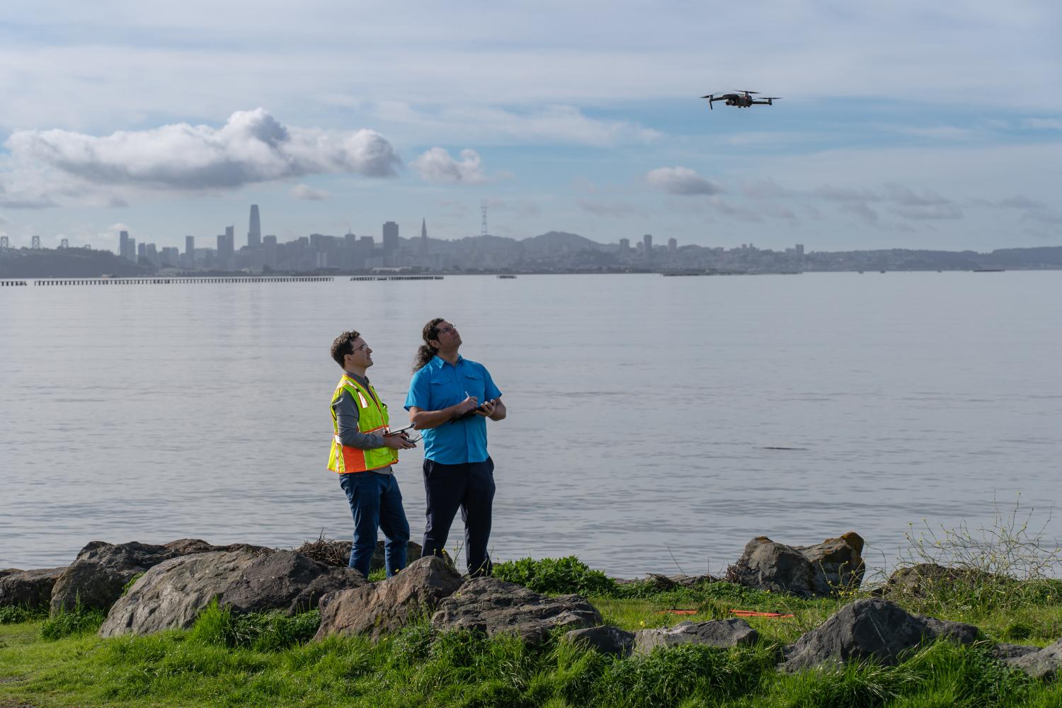 Two men flying a drone