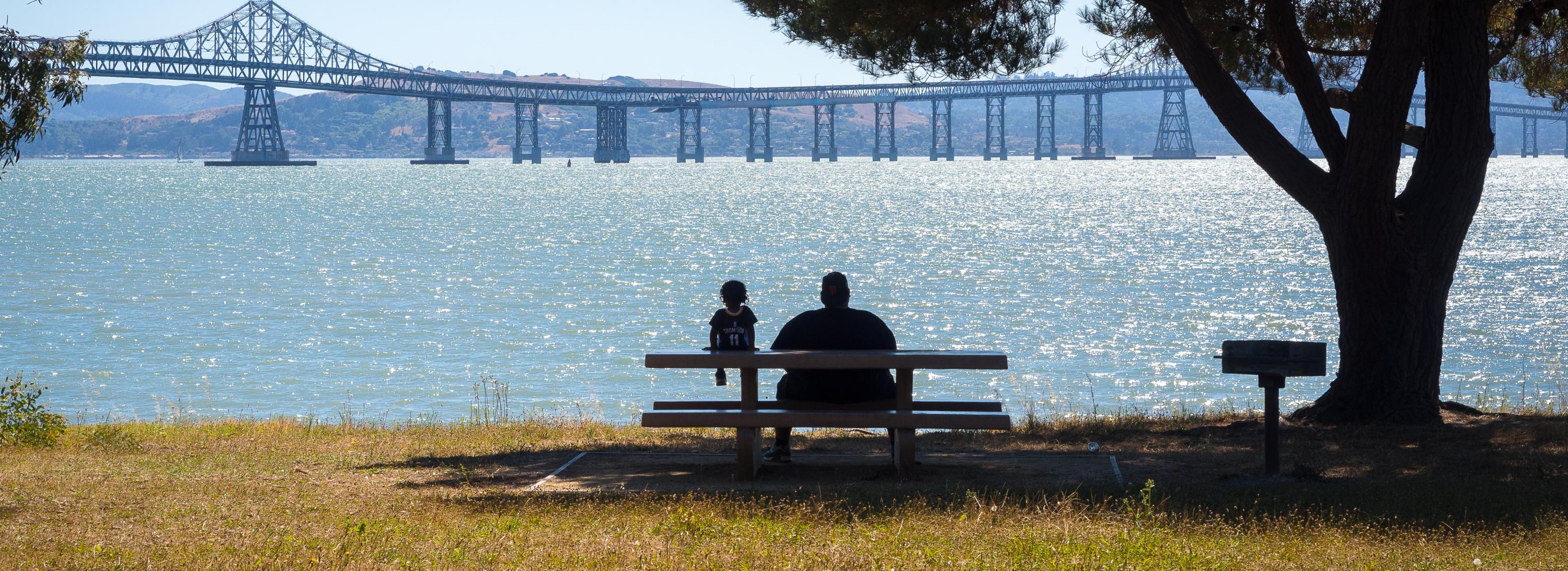 Two people sitting near the Bay
