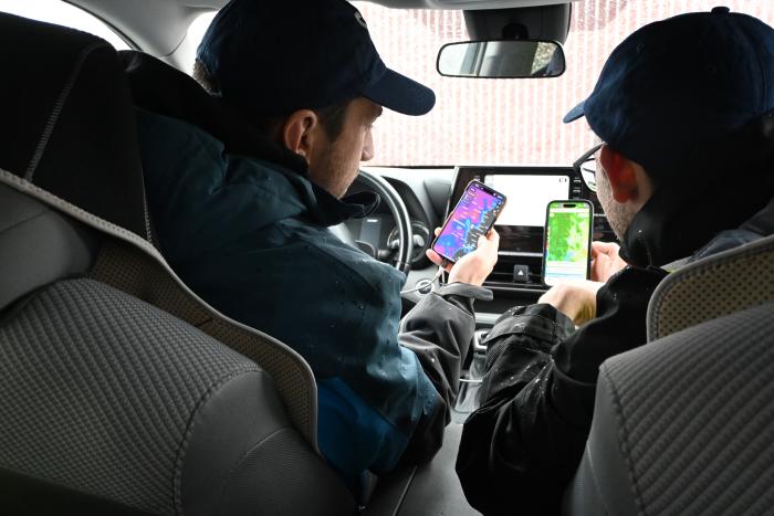 People driving and looking at phones