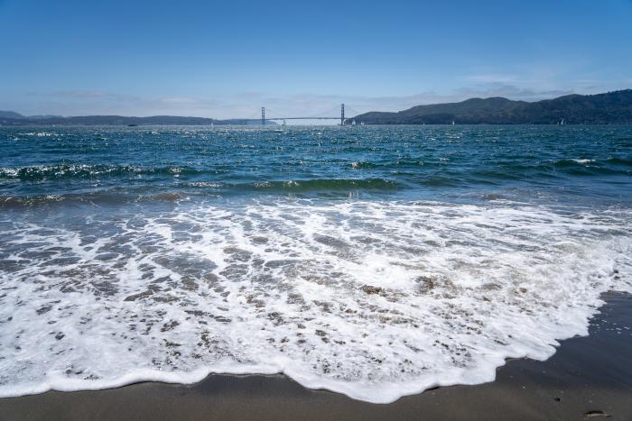San Francisco Bay from a beach with Golden Gate Bridge in the distance