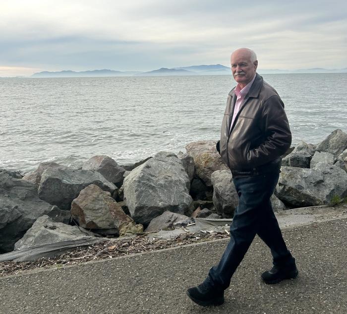Warner Chabot walking at the Bay's edge