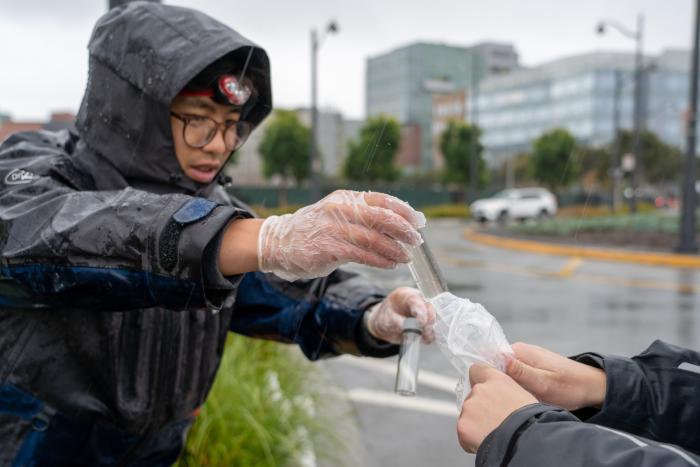 Martin Trinh handles a freshly collected sample during a storm in San Francisco. Photo: Shira Bezalel