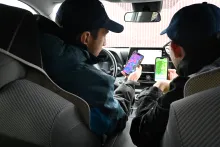 People driving and looking at phones