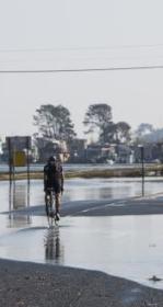 bikes riding on a wetted road