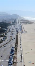 Birdseye of a highway next to a beach