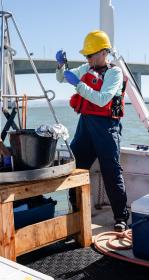 Scientist sampling on a boat
