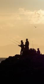 People fishing at sunset