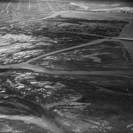 An aerial view looking southwest across extensive mudflats, tidal marsh, and wide sloughs in Mission Bay from 1937