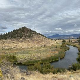 Photo of the Shasta River winding around a hill